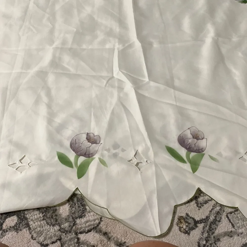 Cream, colored shower curtain with green trimming